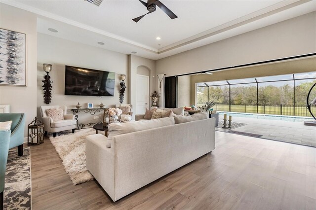 living room featuring ceiling fan and light hardwood / wood-style flooring