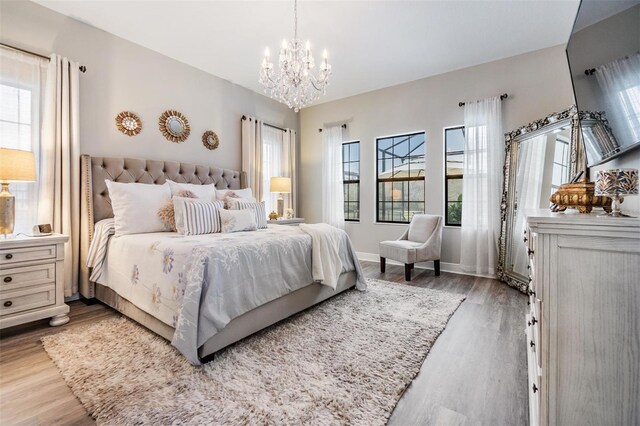 bedroom featuring hardwood / wood-style flooring and a notable chandelier