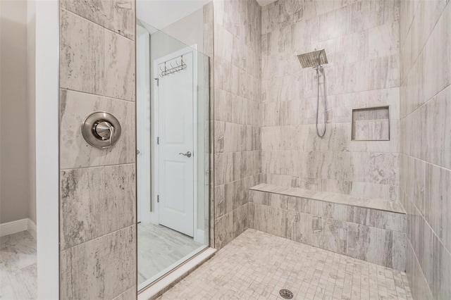 bathroom with tiled shower