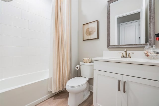 full bathroom with shower / bath combo with shower curtain, hardwood / wood-style floors, vanity, and toilet