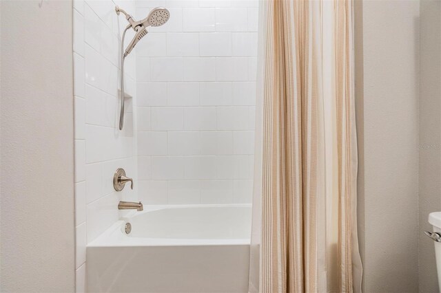 bathroom featuring shower / bath combo and toilet