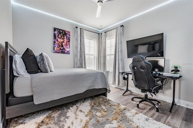 bedroom with ceiling fan and light hardwood / wood-style floors