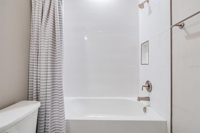 bathroom with toilet and shower / tub combo