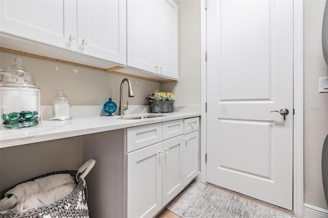 clothes washing area with sink