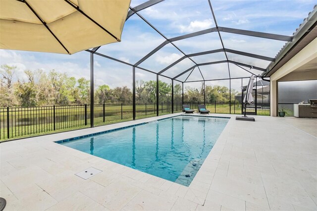 view of pool featuring a patio area, a lanai, and a lawn