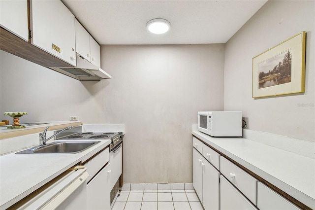 kitchen with white cabinetry, sink, white appliances, and light tile patterned floors