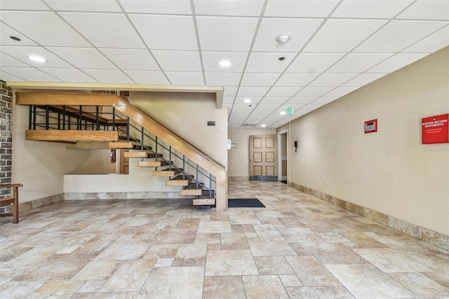 stairs featuring a paneled ceiling