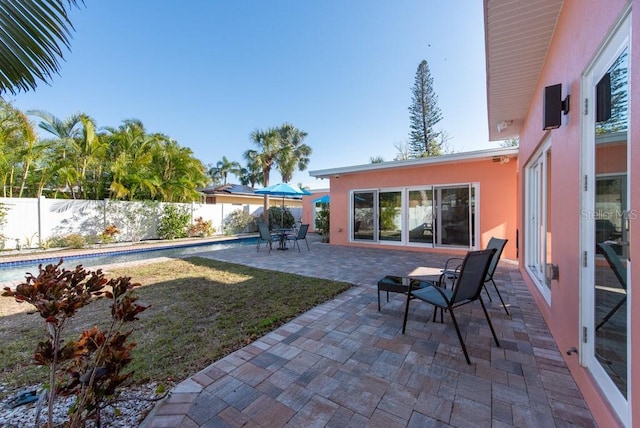 view of yard with a fenced in pool and a patio