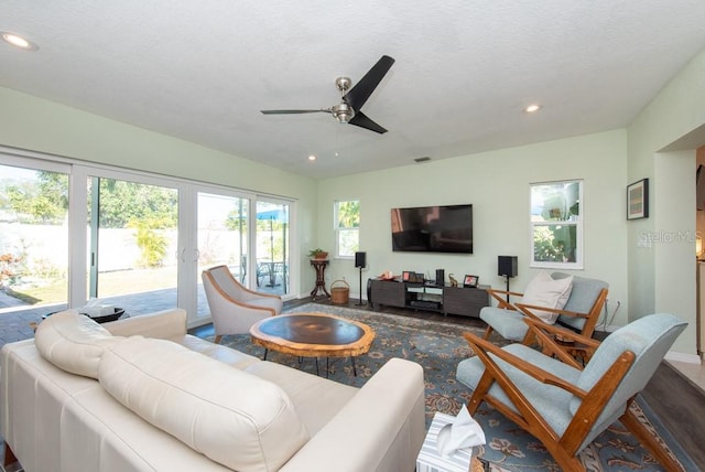 living room featuring french doors, a textured ceiling, ceiling fan, and wood-type flooring