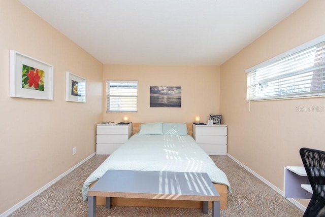 bedroom featuring light carpet and multiple windows