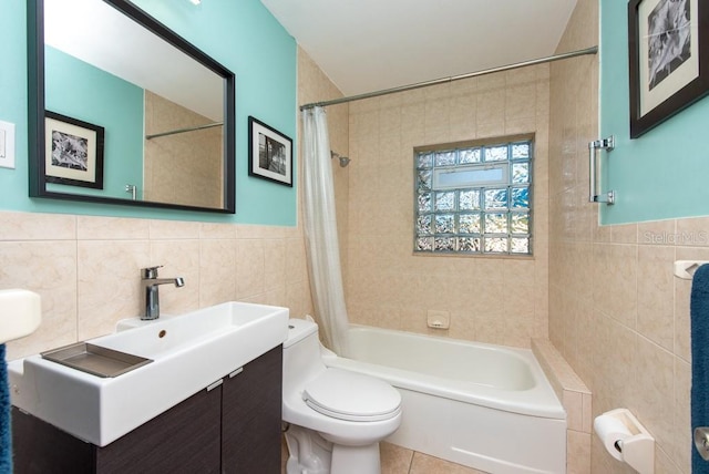 full bathroom featuring tile patterned flooring, vanity, tile walls, and toilet