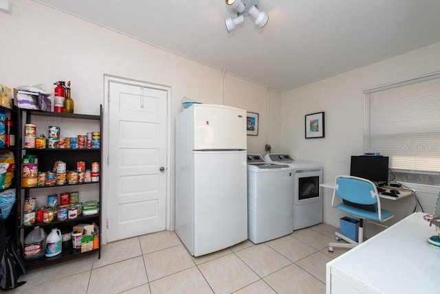 laundry area with light tile patterned flooring and separate washer and dryer