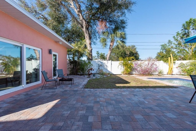 view of patio / terrace featuring a fenced in pool