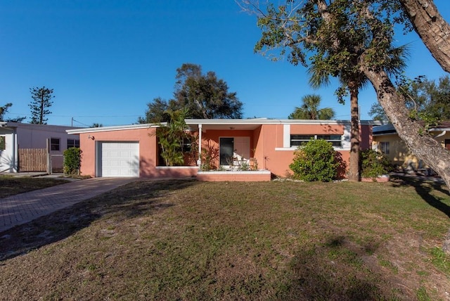 single story home with a front yard and a garage