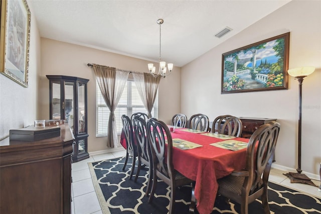 dining room featuring an inviting chandelier, lofted ceiling, and light tile patterned floors