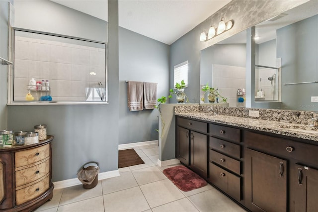 bathroom featuring walk in shower, tile patterned flooring, and vanity