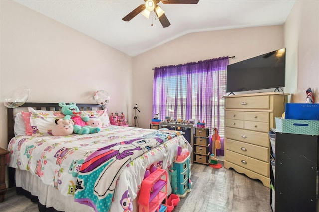 bedroom with hardwood / wood-style floors, ceiling fan, and vaulted ceiling