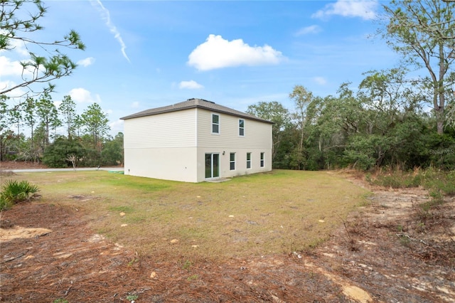 view of side of property with a yard