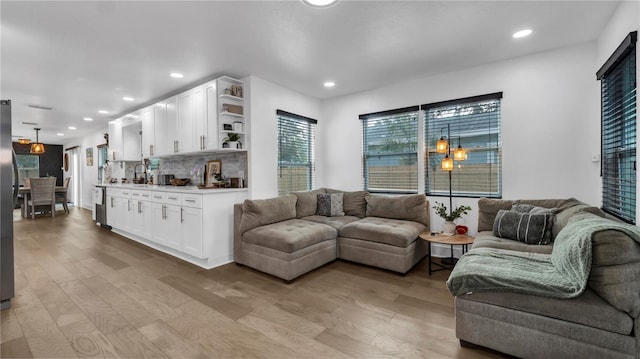 living room with sink and light hardwood / wood-style floors