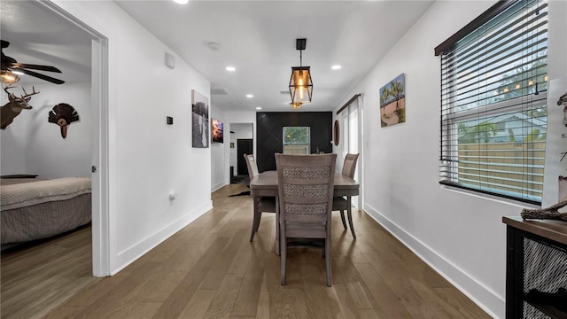 dining area with dark hardwood / wood-style floors and ceiling fan