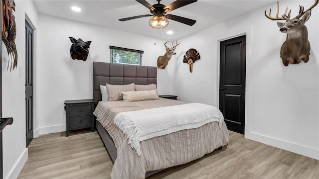 bedroom with ceiling fan and light wood-type flooring