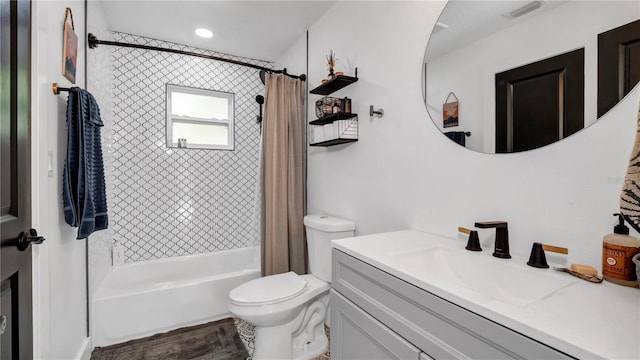 full bathroom featuring shower / tub combo with curtain, vanity, and toilet