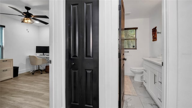 bathroom with vanity, ceiling fan, hardwood / wood-style floors, and toilet