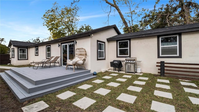 back of house featuring a wooden deck