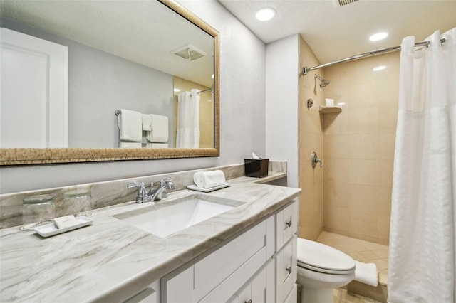 bathroom featuring vanity, toilet, and curtained shower