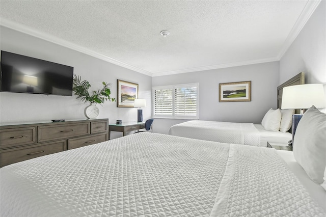 bedroom with a textured ceiling and crown molding