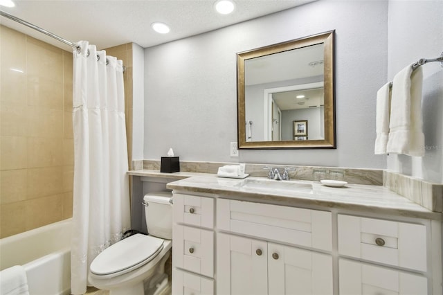 full bathroom featuring shower / tub combo with curtain, vanity, a textured ceiling, and toilet