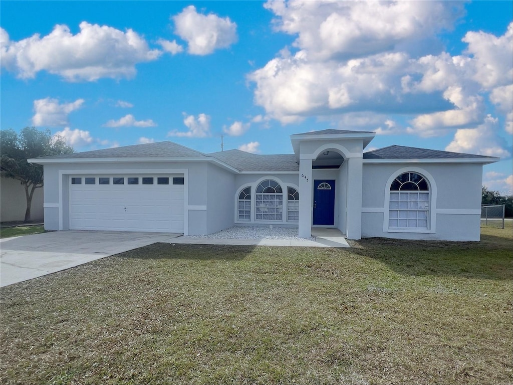 view of front of house with a garage and a front yard