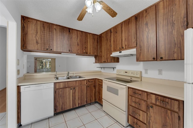 kitchen with a textured ceiling, ceiling fan, white appliances, and sink