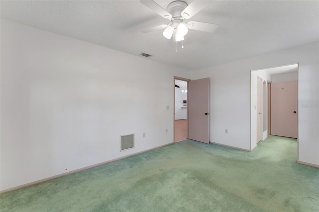 spare room with light carpet and ceiling fan