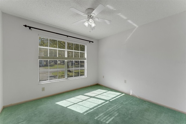 carpeted spare room with ceiling fan and a textured ceiling