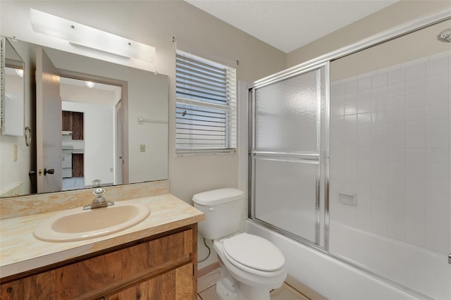 full bathroom with vanity, toilet, and enclosed tub / shower combo