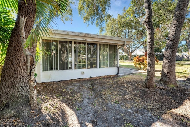 view of property exterior featuring a sunroom