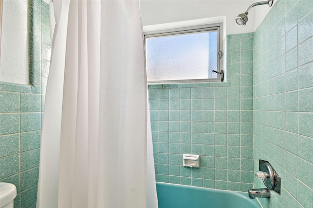 bathroom with shower / tub combo with curtain and toilet