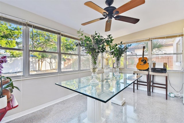 sunroom with ceiling fan and plenty of natural light