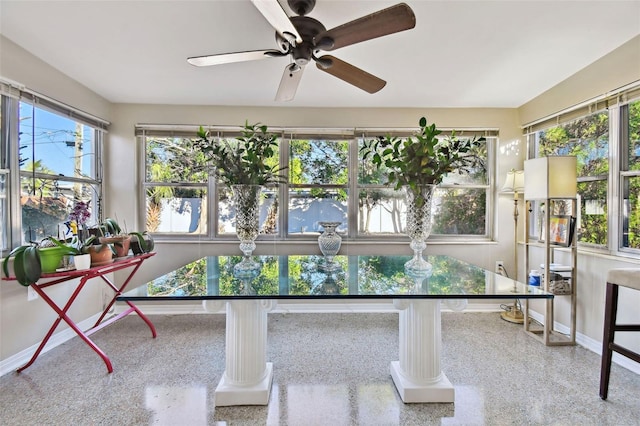 sunroom featuring ceiling fan