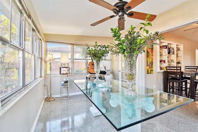 dining space featuring ceiling fan, baseboards, and speckled floor