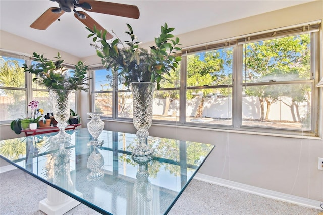 dining room featuring a ceiling fan, baseboards, and speckled floor