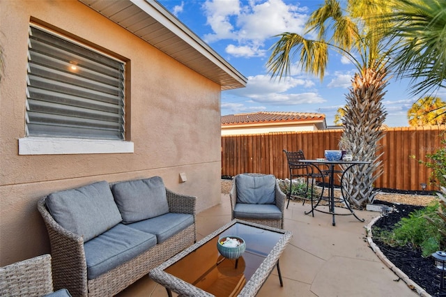 view of patio / terrace featuring outdoor dining area, fence, and an outdoor living space