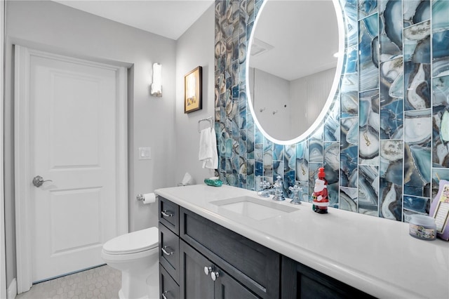 bathroom with toilet and vanity