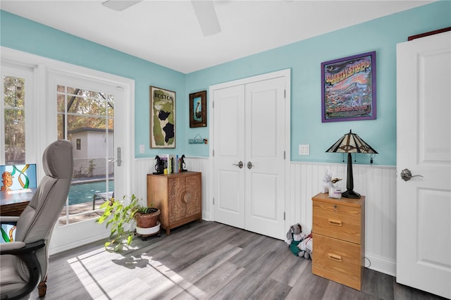 office featuring wood-type flooring, a healthy amount of sunlight, and ceiling fan