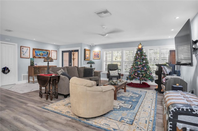 living room featuring ceiling fan and light hardwood / wood-style floors