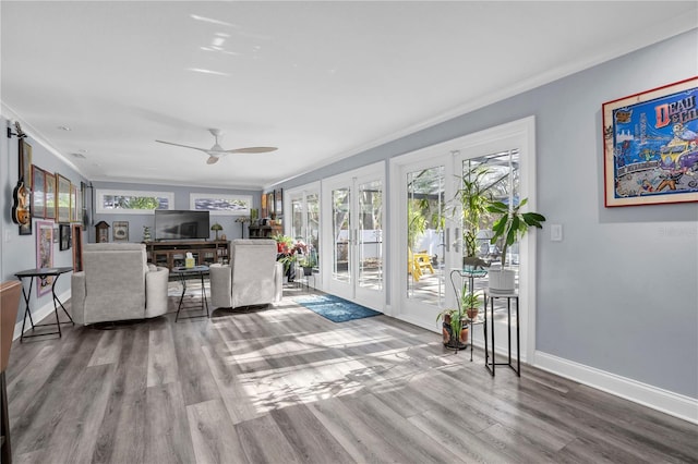 living room with ceiling fan, french doors, ornamental molding, and hardwood / wood-style floors