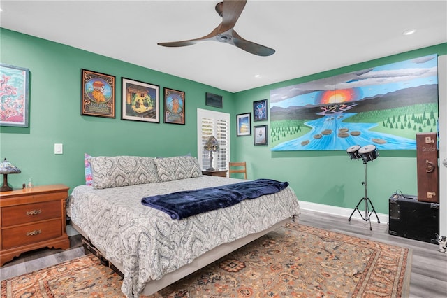 bedroom with ceiling fan and hardwood / wood-style floors