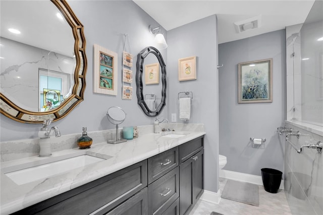 bathroom featuring vanity, toilet, and tile patterned floors