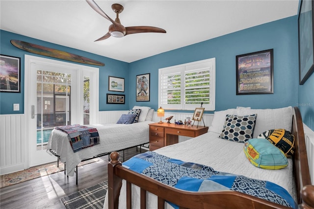 bedroom with ceiling fan, multiple windows, wood-type flooring, and access to outside